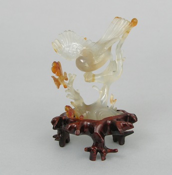 Appraisal: Carved Agate Bird on a Carved Wood Stand A carved