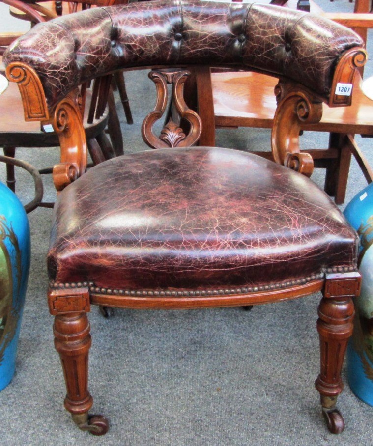 Appraisal: A Victorian walnut framed tub back office chair on turned