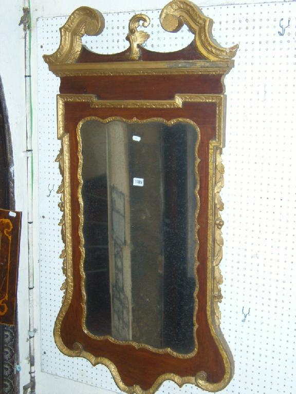 Appraisal: A Georgian wall mirror with shaped and carved outline with