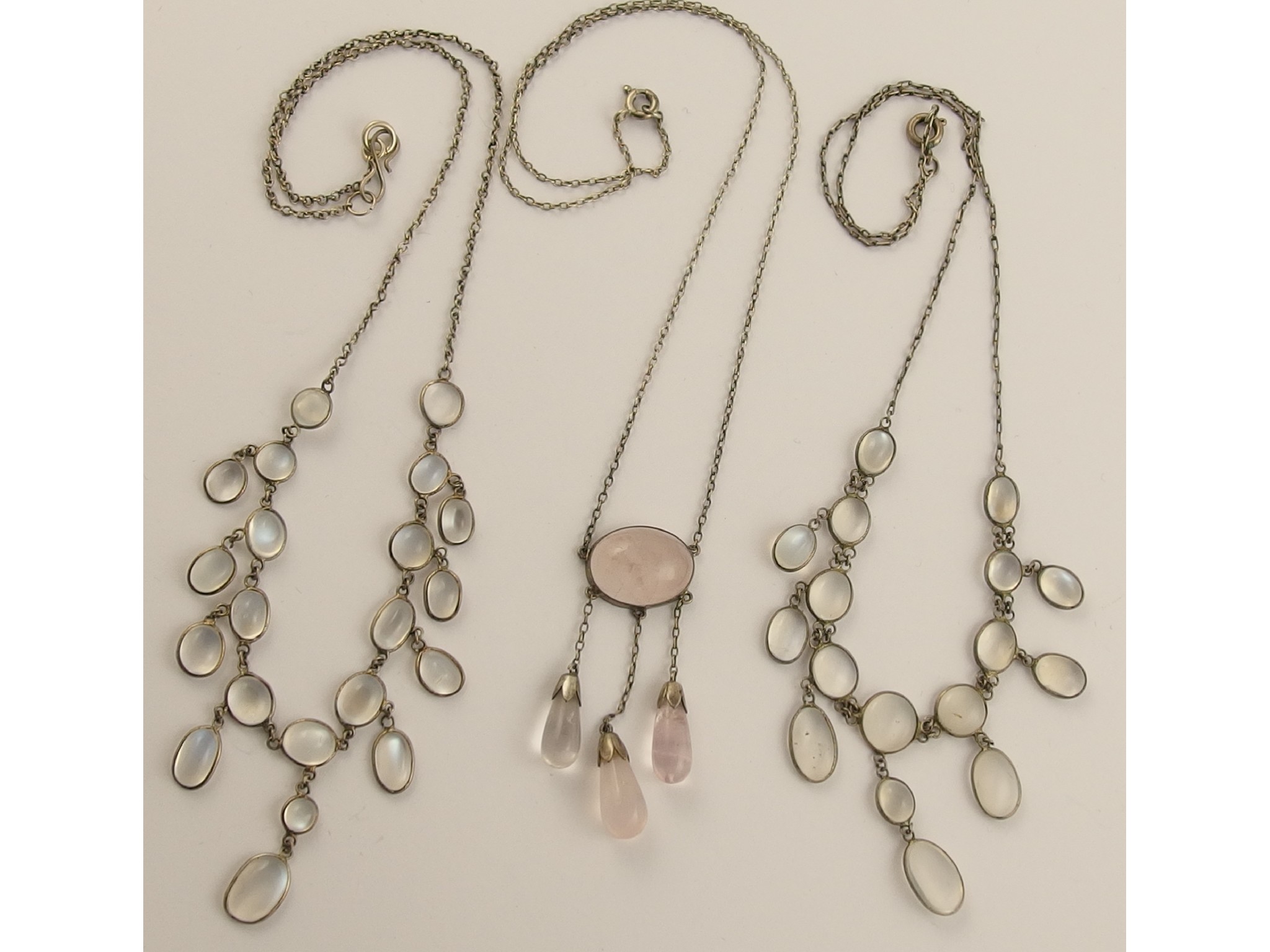 Appraisal: Two moonstone festoon necklaces and a rose quartz pendant necklace