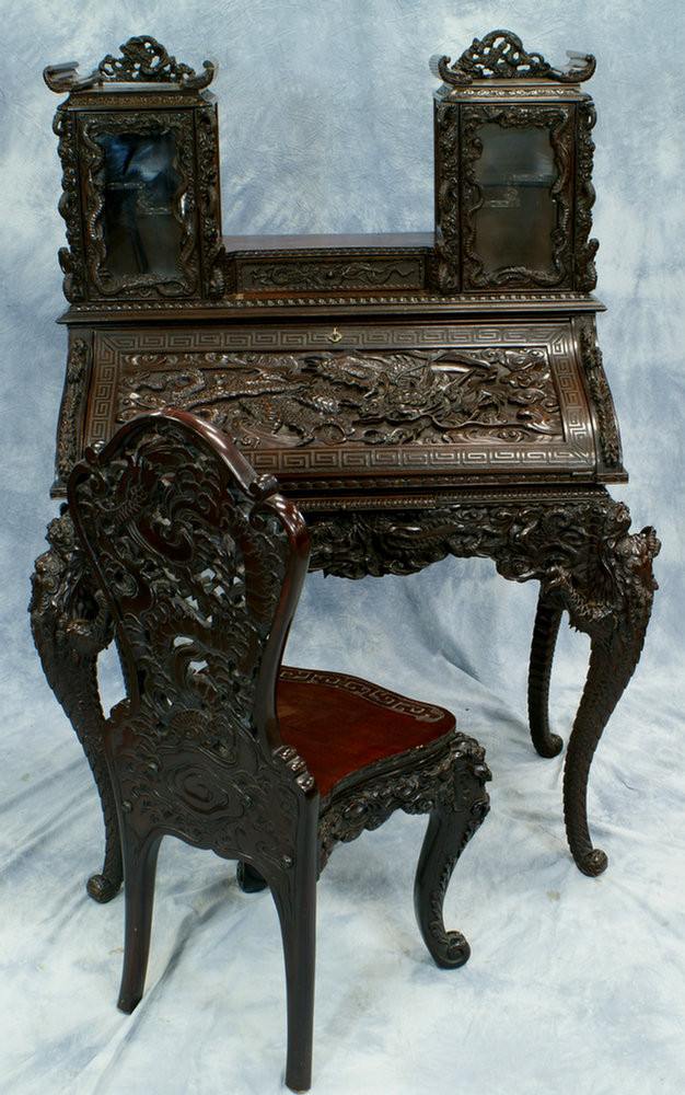 Appraisal: Dragon carved rosewood Chinese desk with chair curio compartments excellent