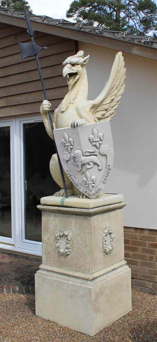 Appraisal: A large pair composition garden statues modelled as griffons seated