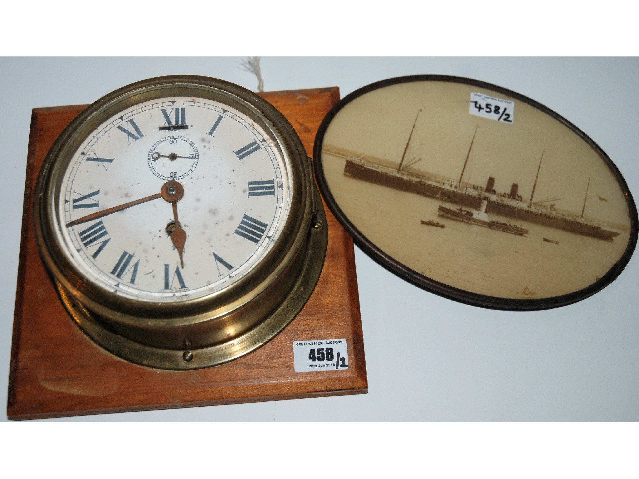 Appraisal: An English made brass bulk head clock and an oval