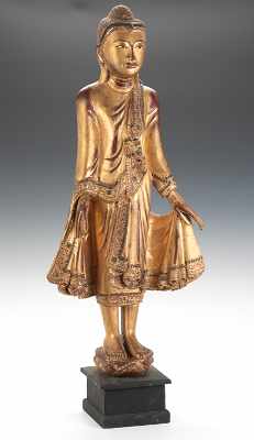 Appraisal: A Carved Wood Standing Buddha Fully carved standing on a