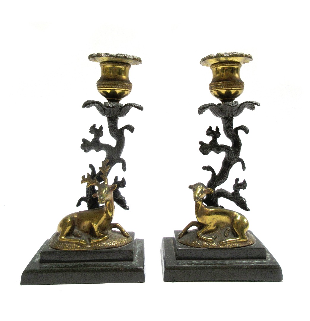 Appraisal: A pair of Regency patinated and gilt bronze candlesticks with