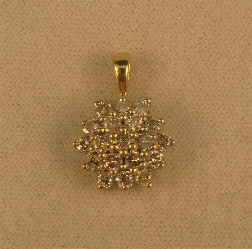 Appraisal: DIAMOND AND FOURTEEN KARAT GOLD CLUSTER PENDANT set with round-cut