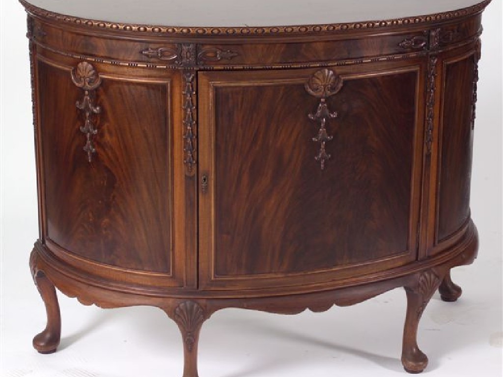 Appraisal: GEORGE III STYLE MAHOGANY DEMILUNE SIDEBOARD the top carved with