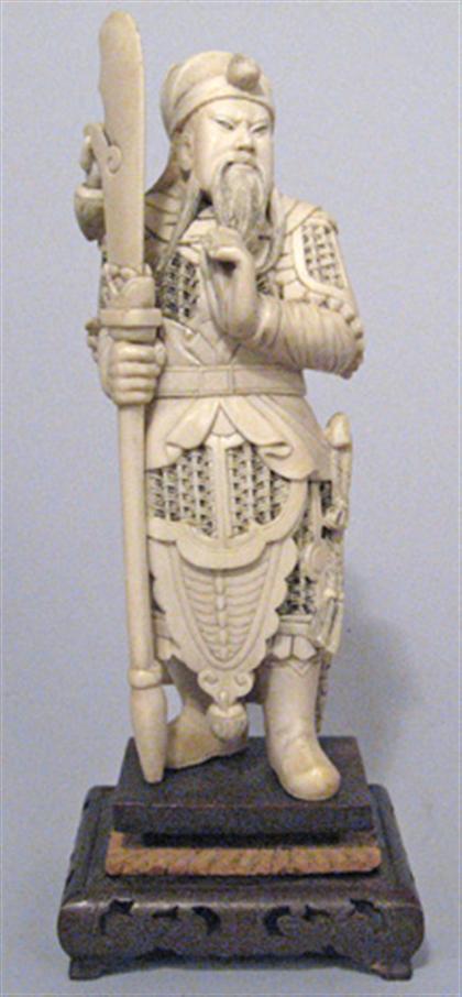 Appraisal: Chinese elephant ivory guardian model Well carved standing figure holding