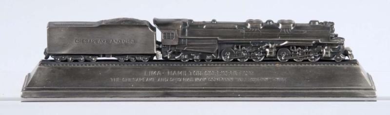 Appraisal: Cast Metal Chesapeake Ohio Train Desk Piece Description Depicts steam