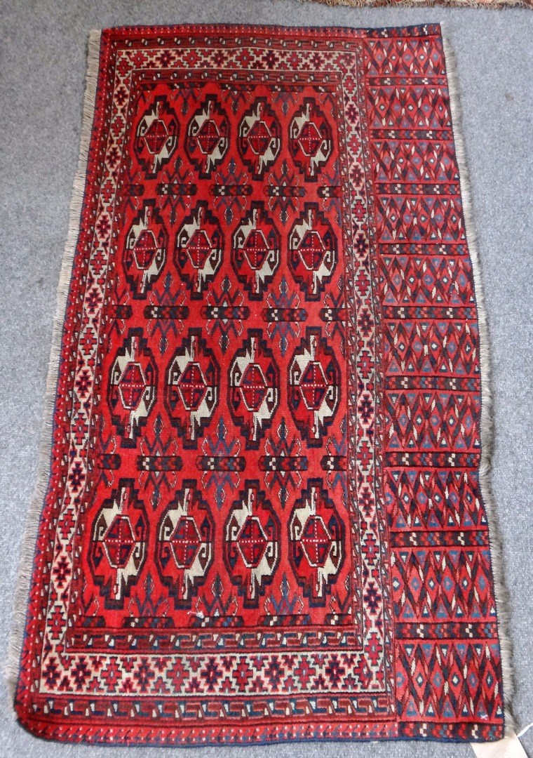 Appraisal: A Turkeman Engsi mat orange red ground with four rows