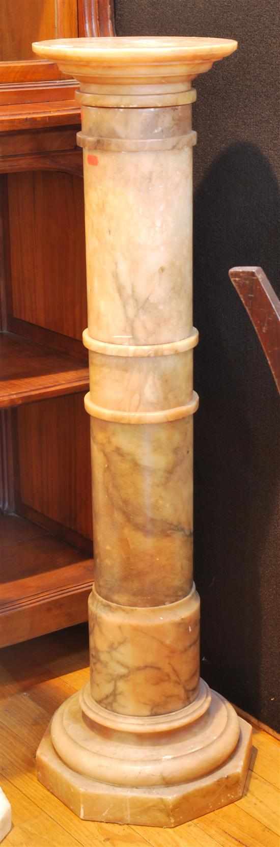 Appraisal: An alabaster pedestal The cylindrical stem above an octagonal foot