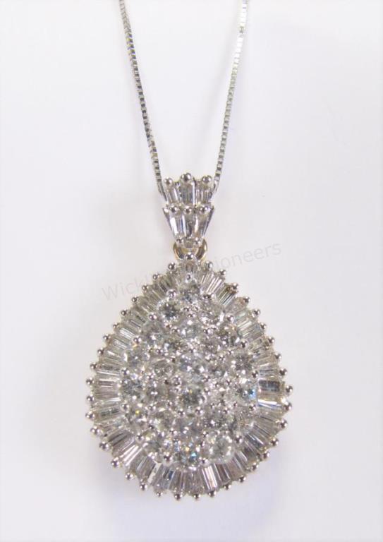 Appraisal: A K white gold pear shaped diamond cluster pendant containing