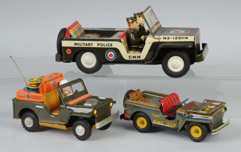 Appraisal: Lot of Tin Military Jeep Friction Toys Description Japanese Working