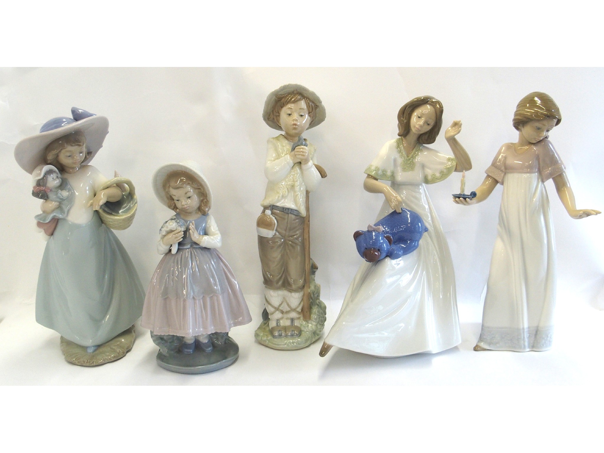 Appraisal: Five Nao figures including a lady sewing a teddy bear