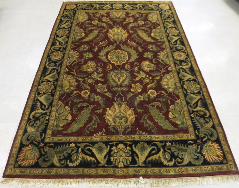 Appraisal: HAND KNOTTED ORIENTAL CARPET Indo-Persian overall foliate design on plum