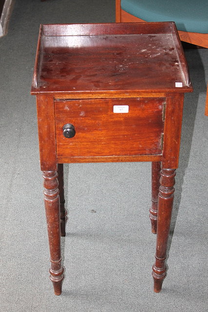 Appraisal: A VICTORIAN MAHOGANY POT CUPBOARD enclosed by single door on