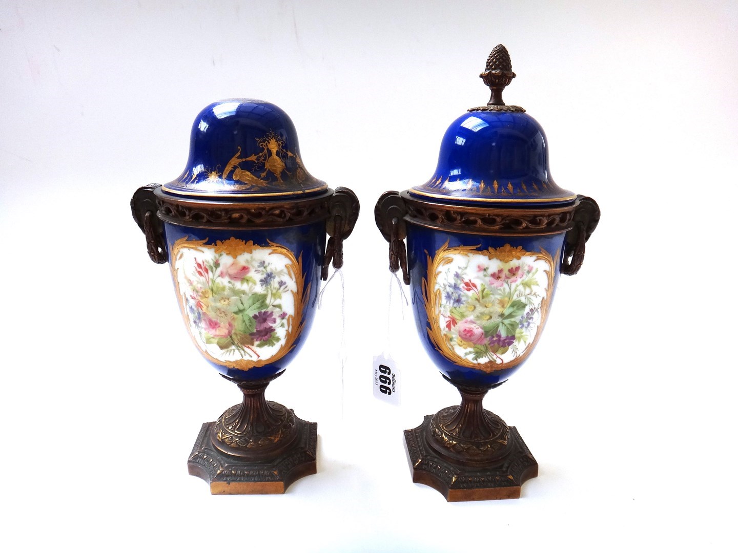 Appraisal: A pair of Continental porcelain and bronze mounted lidded urns