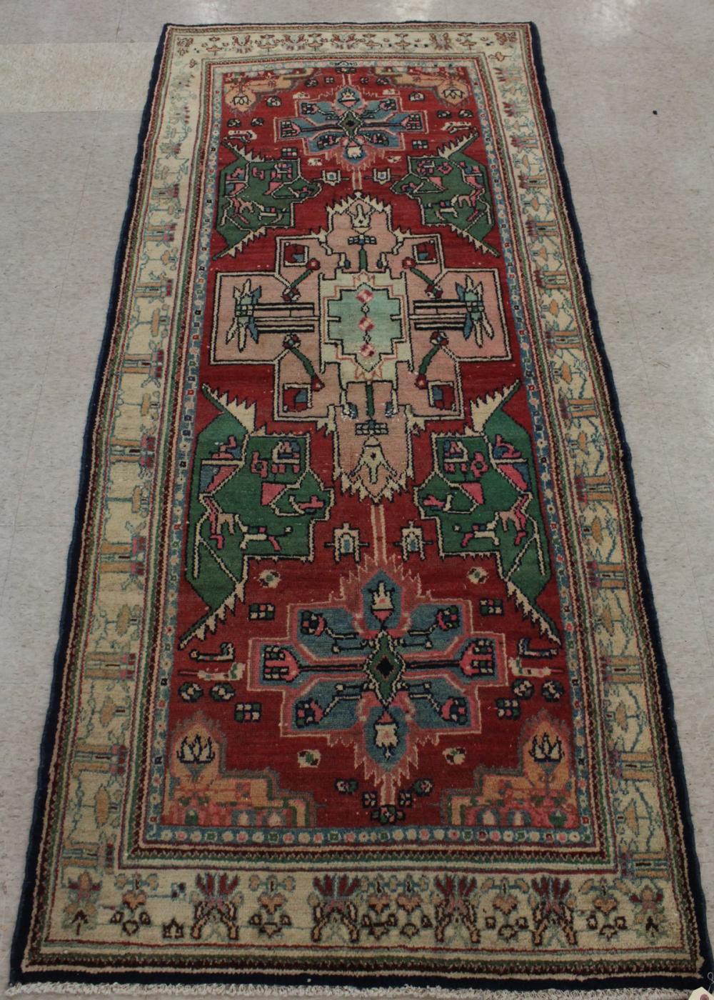 Appraisal: HAND KNOTTED PERSIAN AREA RUG geometric design on red ground