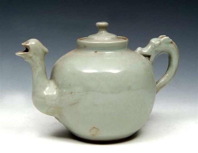 Appraisal: A CHINESE CELADON TEAPOT with dragon handle across and a