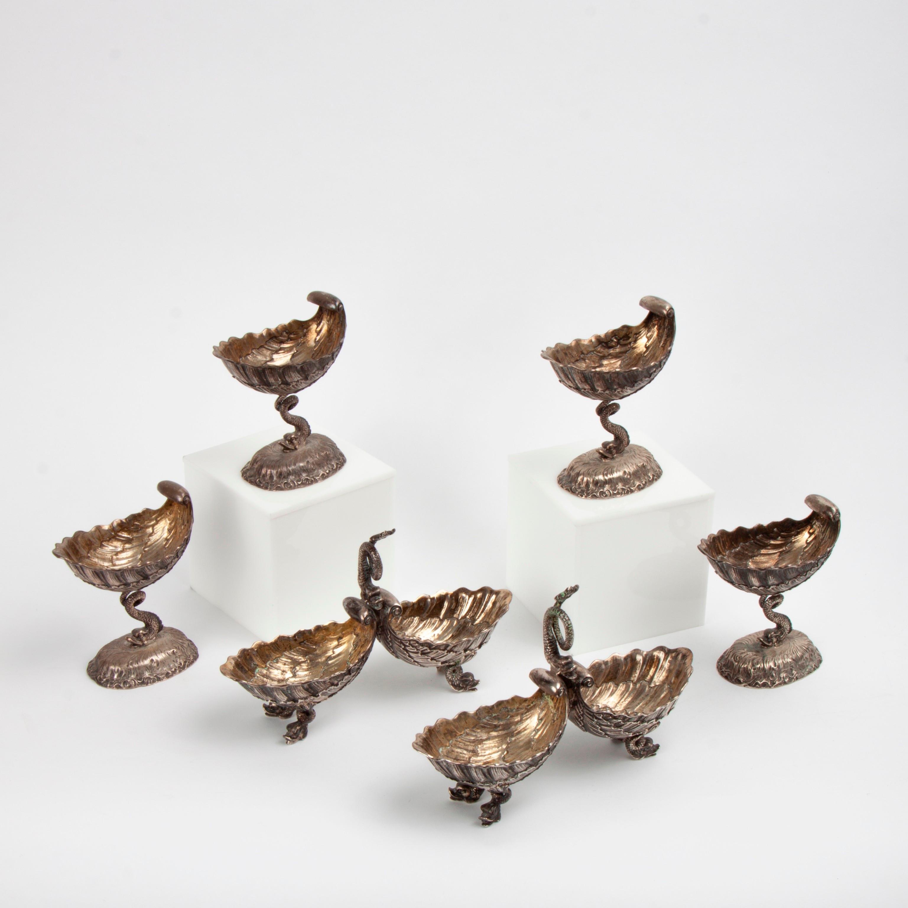 Appraisal: SIX SILVER DOLPHIN AND SHELL TABLEWARE ITEMS Four silver-plated master