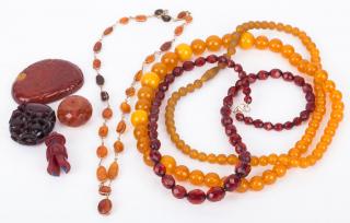 Appraisal: Two long strands of amber beads Amber lariat necklace Hand