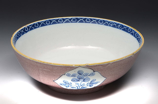 Appraisal: A LAMBETH DELFT POWDERED MANGANESE CIRCULAR BOWL decorated with blue