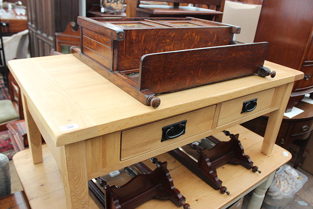 Appraisal: A MODERN OAK COFFEE TABLE with four drawers inches wide