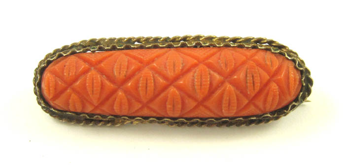 Appraisal: CARVED RED CORAL BROOCH having a bezel set carved coral