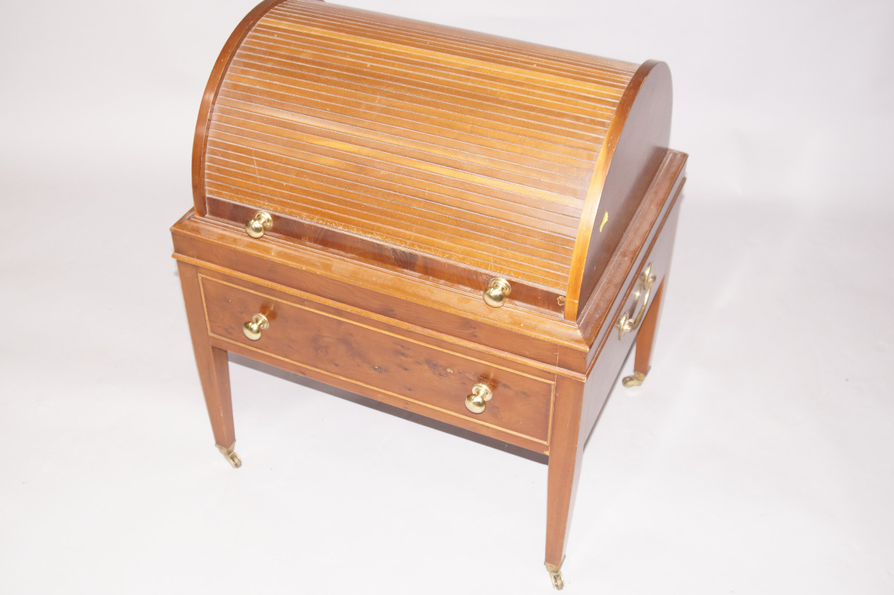 Appraisal: A yew veneered Georgian style sewing stand with cylinder tamber