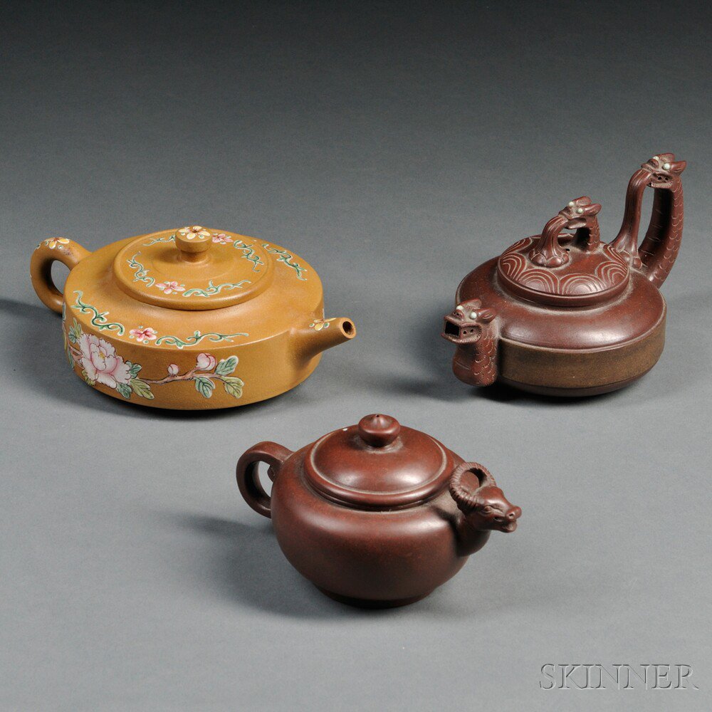 Appraisal: Three Teapots China an ovoid pot with an ox-form spout