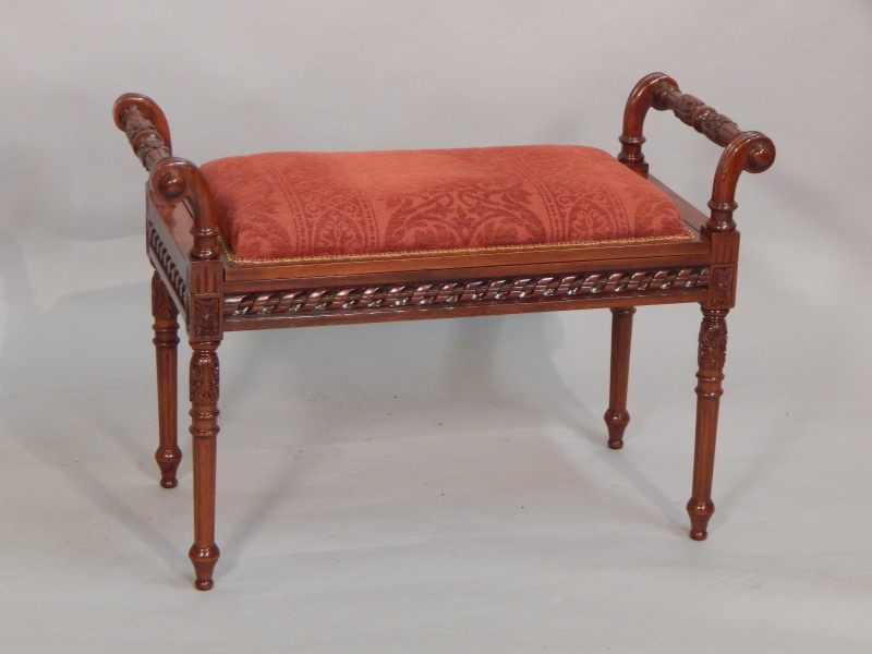 Appraisal: A reproduction mahogany piano stool with a padded seat and