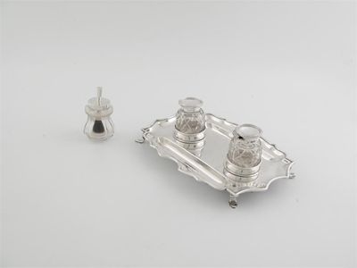 Appraisal: A rectangular inkstand with moulded wavy border and pad feet