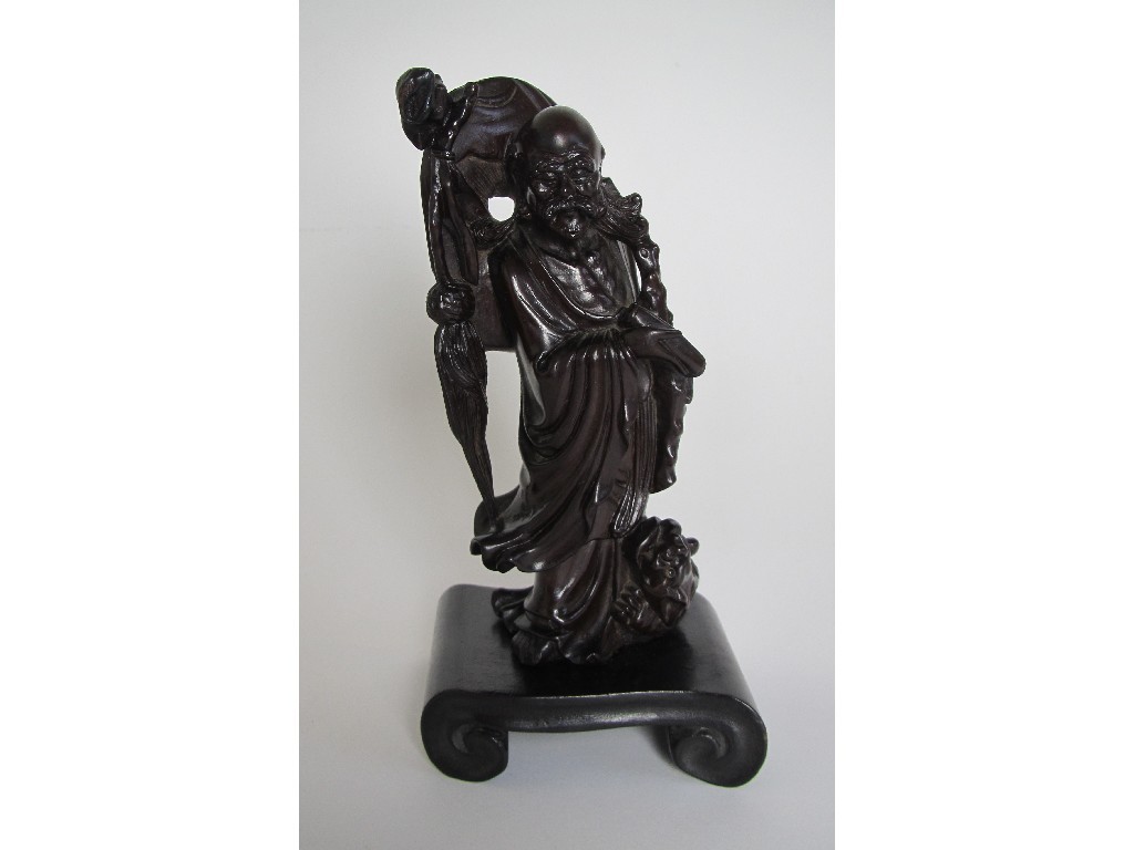 Appraisal: A Chinese carved hardwood figure of a sage on scroll