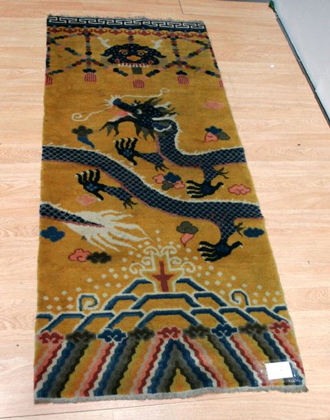 Appraisal: A Tibetan pillar rug yellow background with central dragon motif