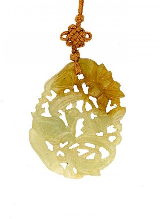 Appraisal: A CHINESE JADE PENDANT carved to either side and pierced