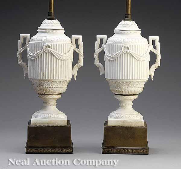 Appraisal: A Pair of Belle poque White Bisque Covered Urns late