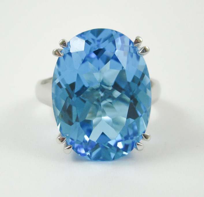 Appraisal: BLUE TOPAZ AND FOURTEEN KARAT WHITE GOLD RING featuring an