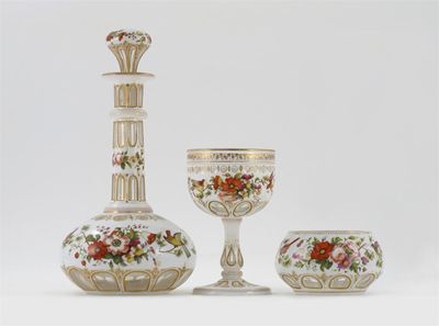 Appraisal: An overlaid glass decanter and stopper a goblet and a