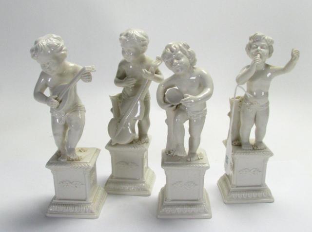 Appraisal: Four Italian Figurines depicting Putti Musicians approximately '' tall stamped