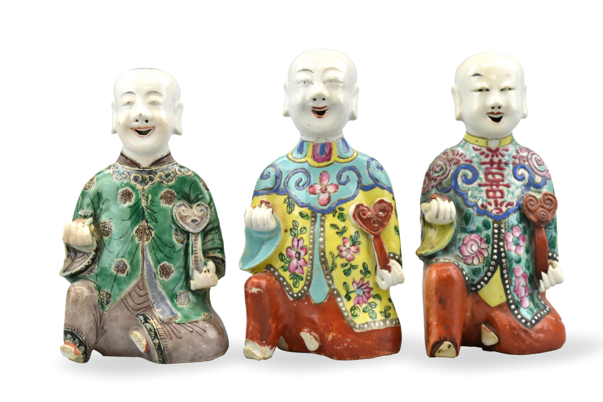 Appraisal: Three Chinese famille rose figures of smiling boys holding a