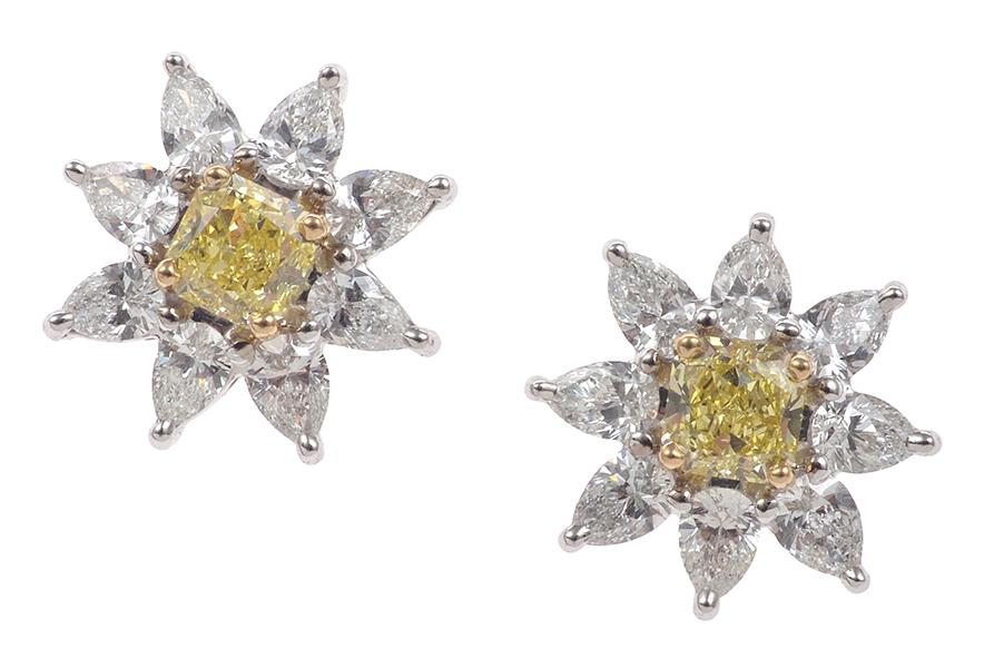 Appraisal: A PAIR OF YELLOW DIAMOND CLUSTER EARRINGS Each centrally set