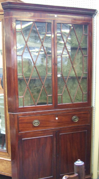 Appraisal: A George III mahogany corner cupboard probably Scottish with a