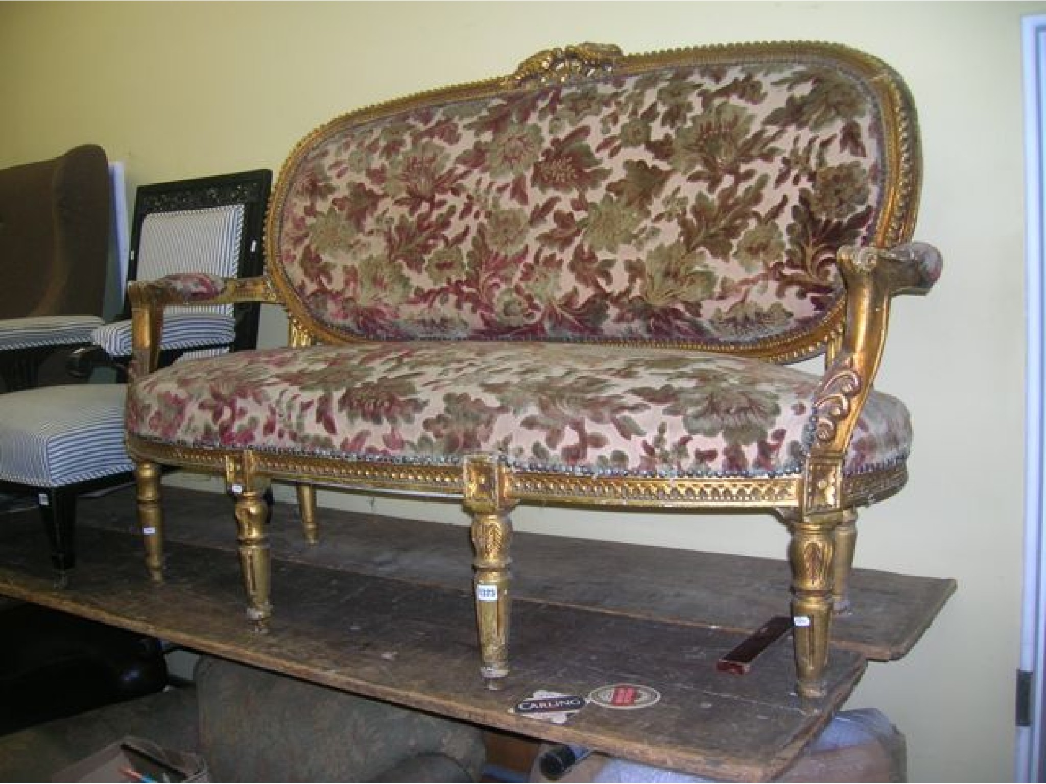 Appraisal: A continental sofa with a carved and gilded show wood