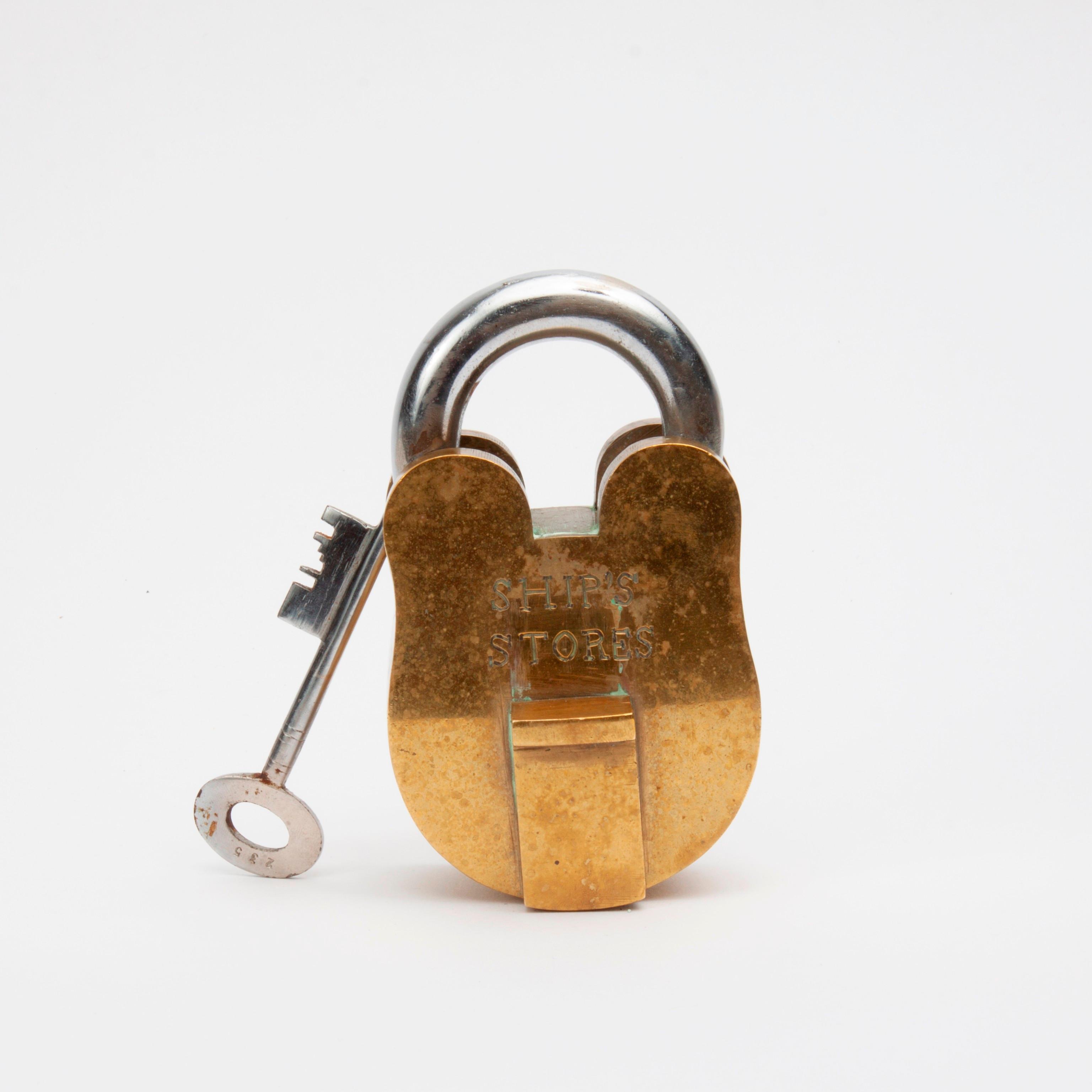 Appraisal: SHIP'S STORES' BRASS LOCK AND KEY A nautical brass padlock