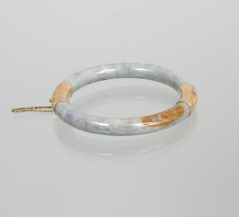 Appraisal: A Carved Jade Hinged Bangle Bracelet with k Gold Mounts