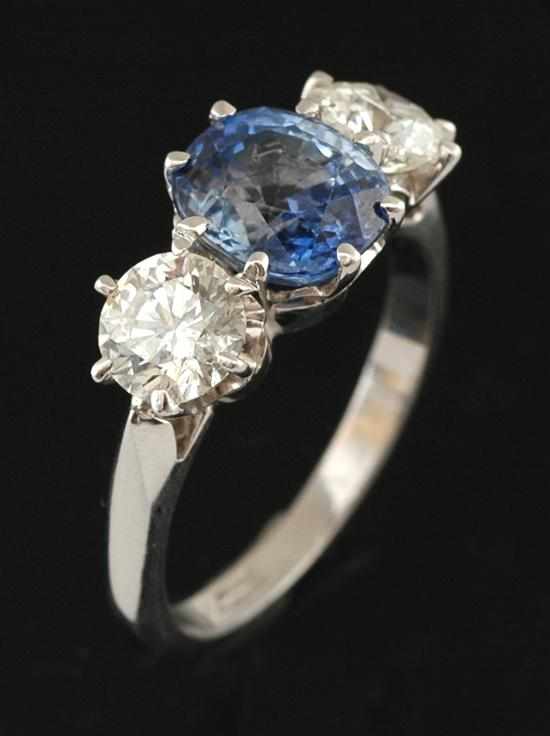 Appraisal: A sapphire and diamond ring Centrally claw set with an