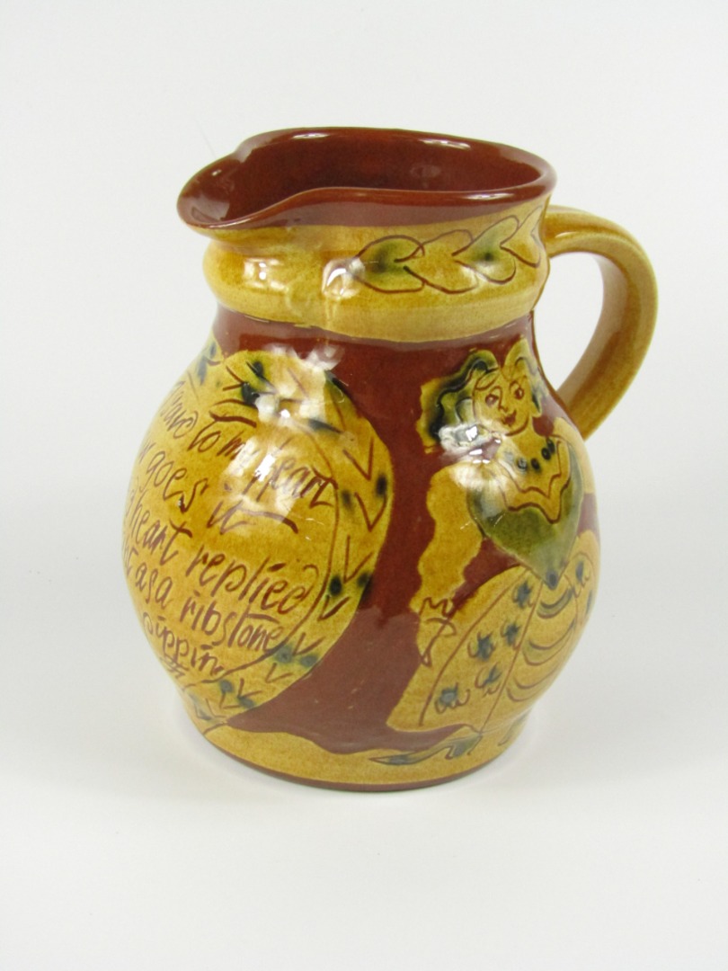 Appraisal: An advertising slipware jug of baluster form decorated with 'I