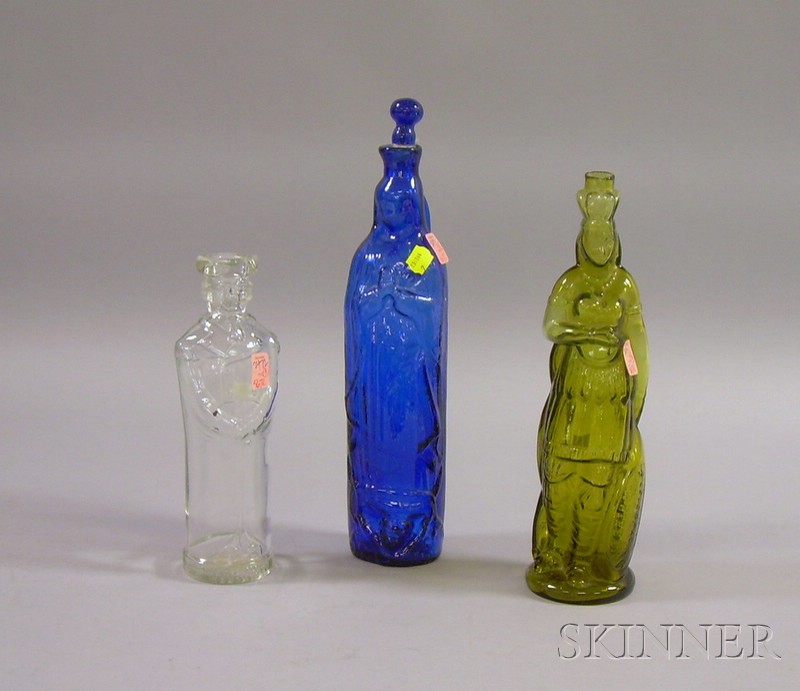 Appraisal: Three Molded Figural Glass Bottles a colorless George Washington cobalt