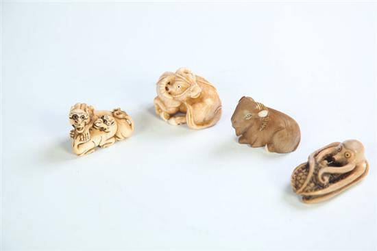 Appraisal: FOUR NETSUKES Japan th century ivory Lions ram water buffalo