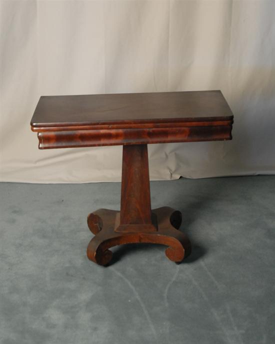 Appraisal: Empire Mahogany Folding-top Game Table having an ogee molded apron